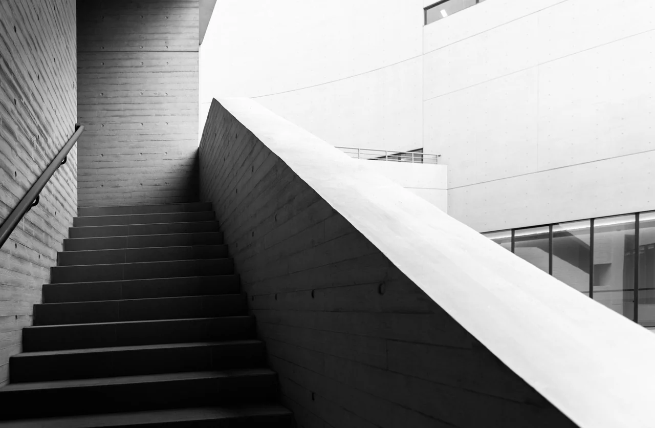 A broad stairway and concrete walls in black and white